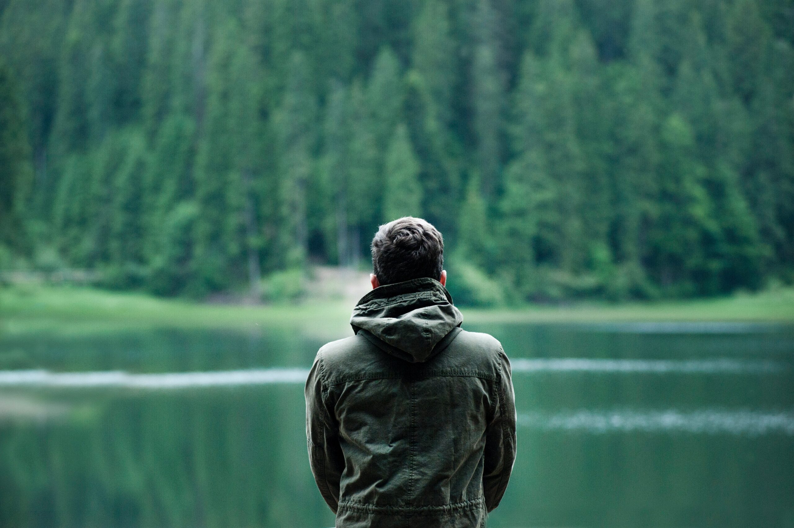 A man standing by a lake
