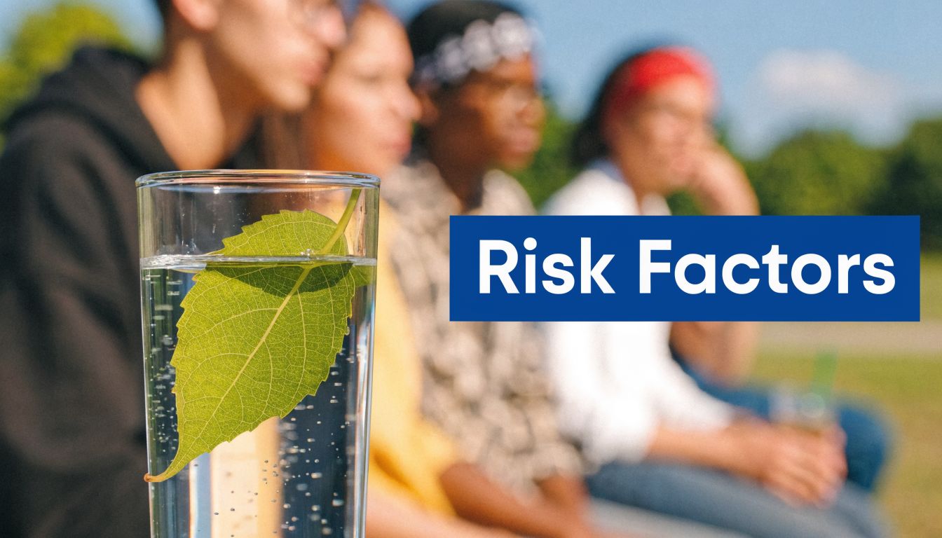 A close-up of a glass of water containing a green leaf with people blurred in background.