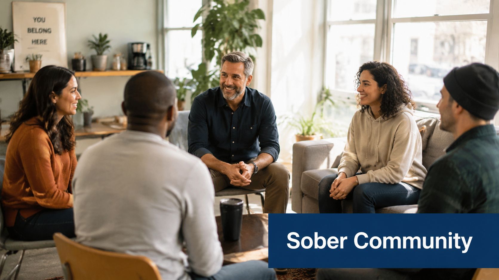 A diverse group of people sitting in a circle during a supportive sober community therapy meeting.