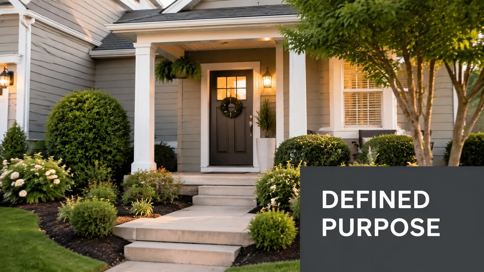 A welcoming front entrance of a modern home with landscaping, a dark front door, and stairs.