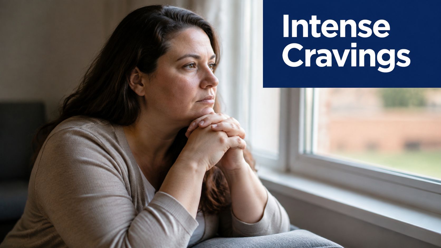 A woman looks out a window with a serious, pensive expression, suggesting intense emotional struggle or cravings.