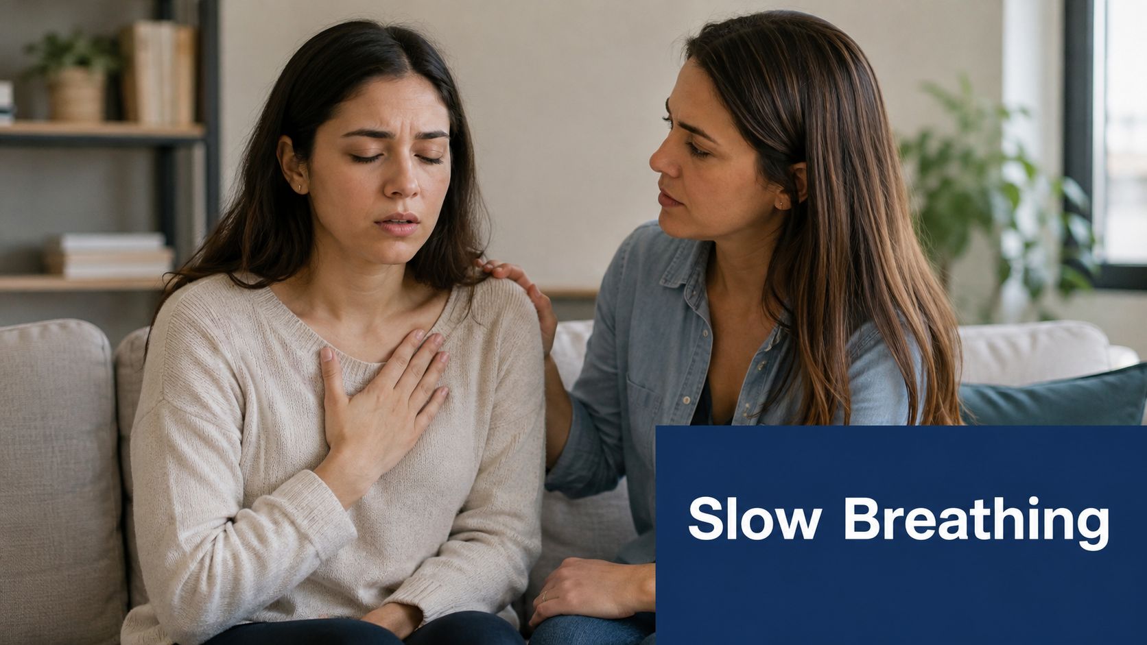 A woman comforts another woman who appears to be having difficulty breathing while sitting on a couch.
