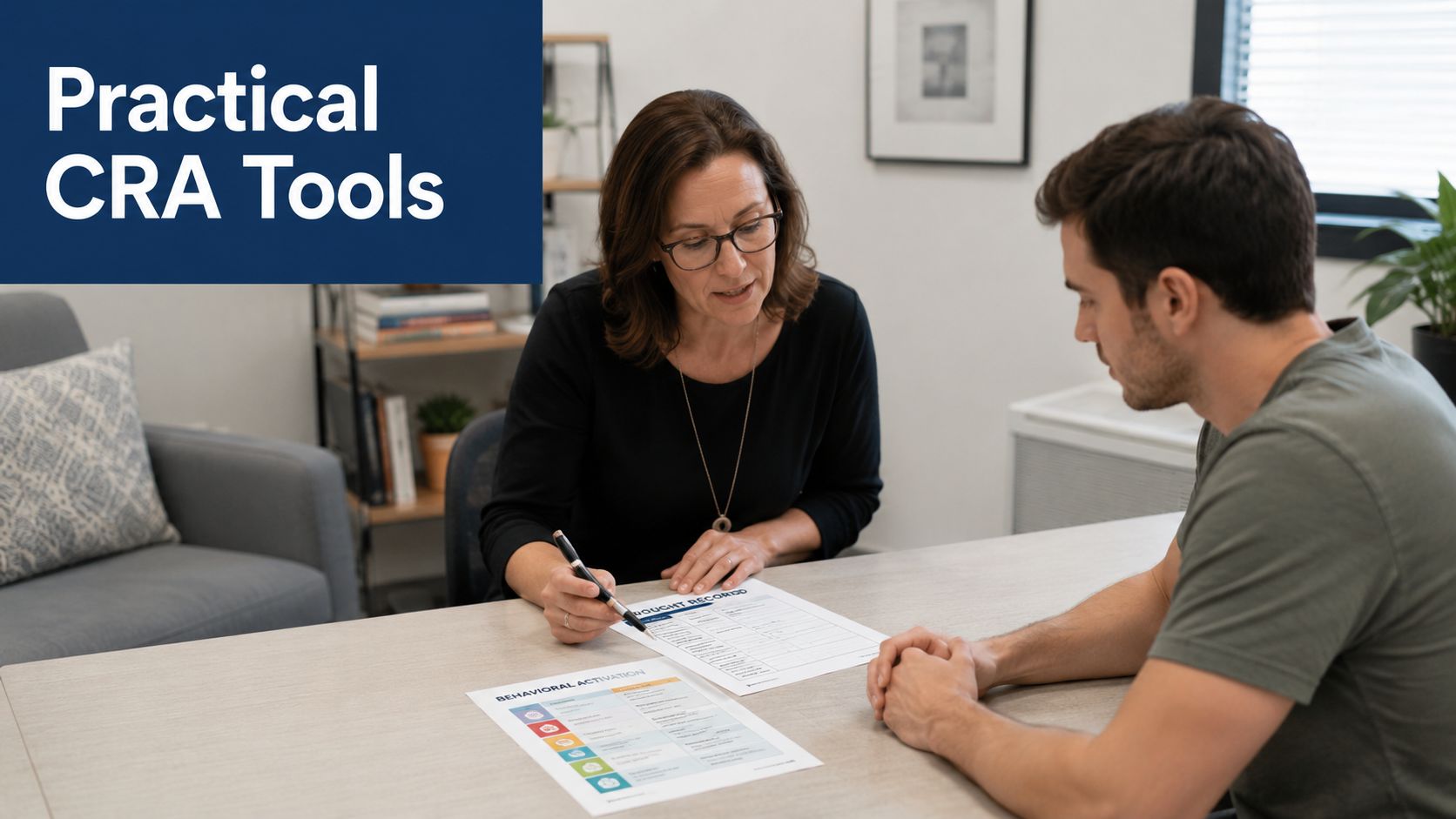 A therapist guides a male patient through a behavioral activation exercise in a professional office setting.